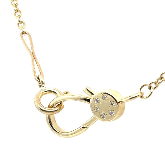 Gold necklace with a unique clasp design on a white background