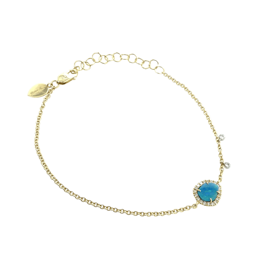 A delicate yellow gold chain bracelet by Meira T featuring a central oval blue opal surrounded by a diamonds, displayed on a clean white background at Lindy's Jewelry.